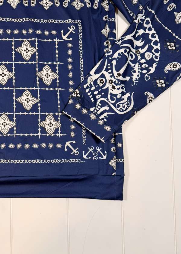 Navy blue bandana with white patterns on a light wooden surface
