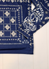 Navy blue bandana with white patterns on a light wooden surface