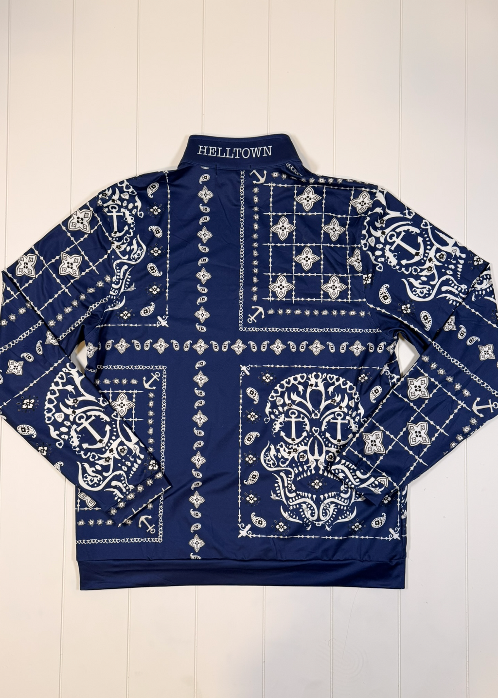 Navy blue jacket with white bandana pattern on a white wooden background