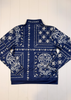 Navy blue jacket with white bandana pattern on a white wooden background