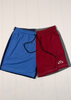Blue and red shorts with a logo on a white wooden background