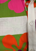 Close-up of a fabric with colorful floral patterns and a white shirt collar.