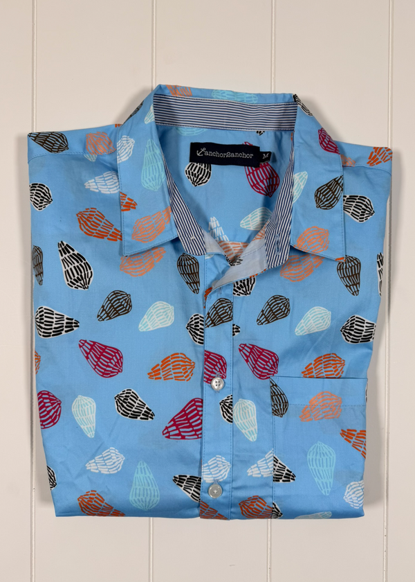 Blue shirt with colorful shell pattern on a white background