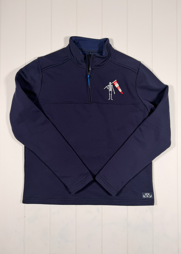 Navy blue jacket with a logo on a light wooden surface