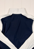 Navy sleeveless top with white trim on a light wooden surface