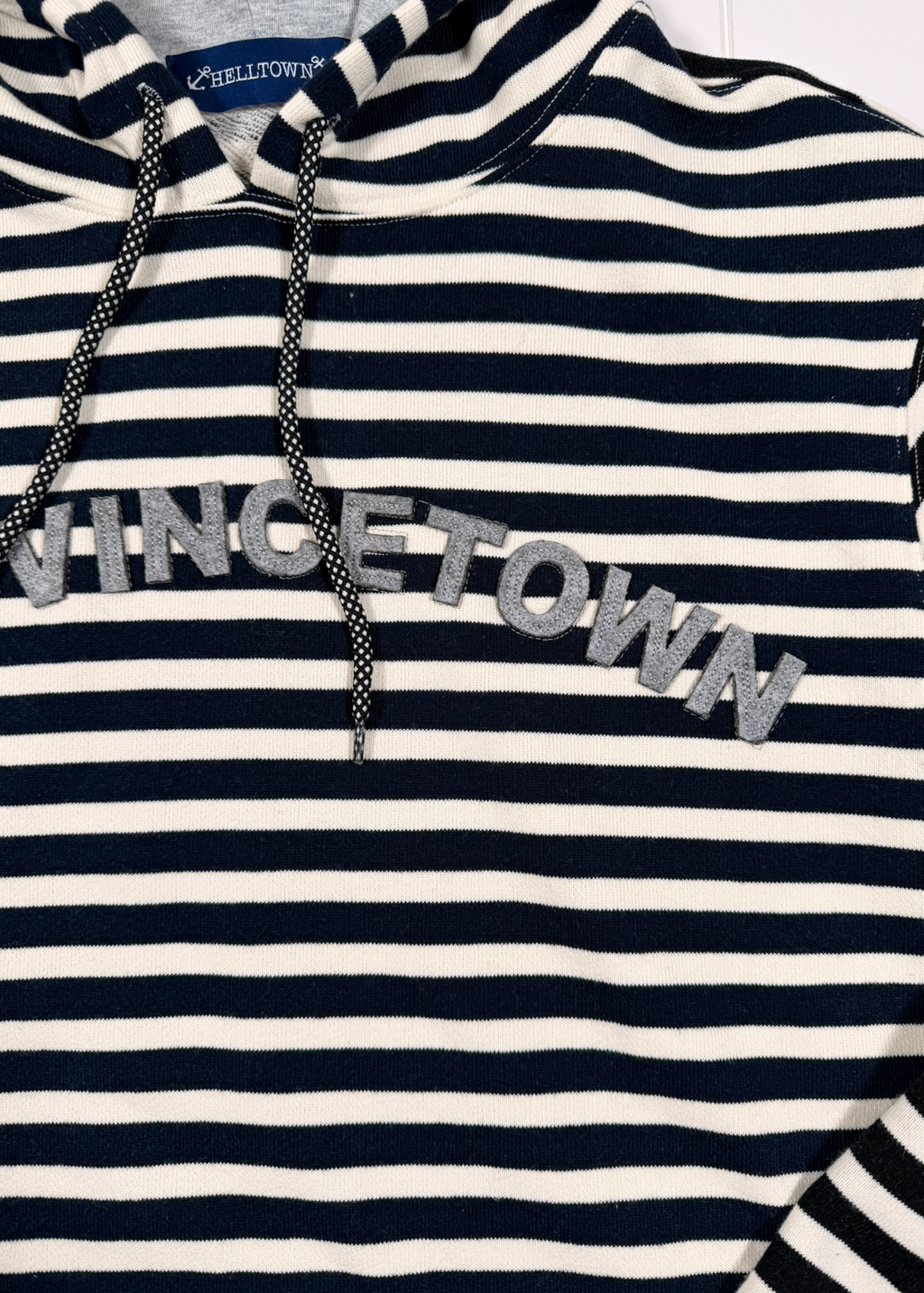 Navy and white striped hoodie with 'Vinetown' text on a plain background