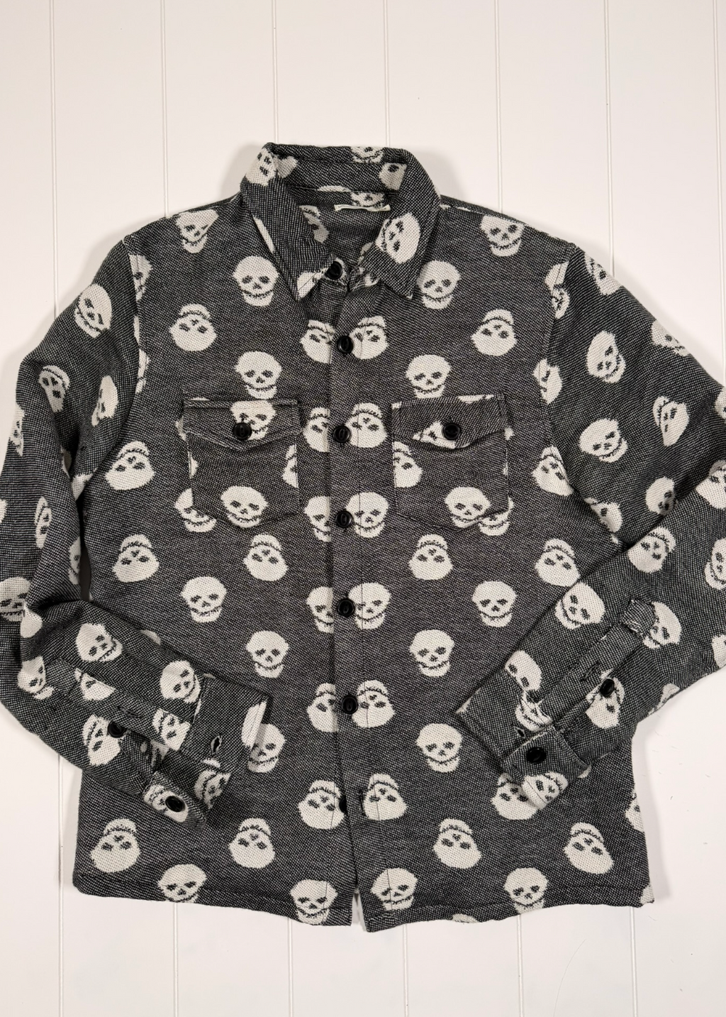 Gray shirt with skull pattern on a white background