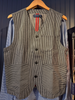 Striped vest on a hanger against a dark blue background