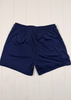 Navy blue shorts on a white wooden surface