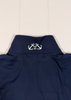 Navy blue garment with white anchor design on a light wooden background