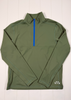 Green pullover with a blue zipper on a white wooden surface