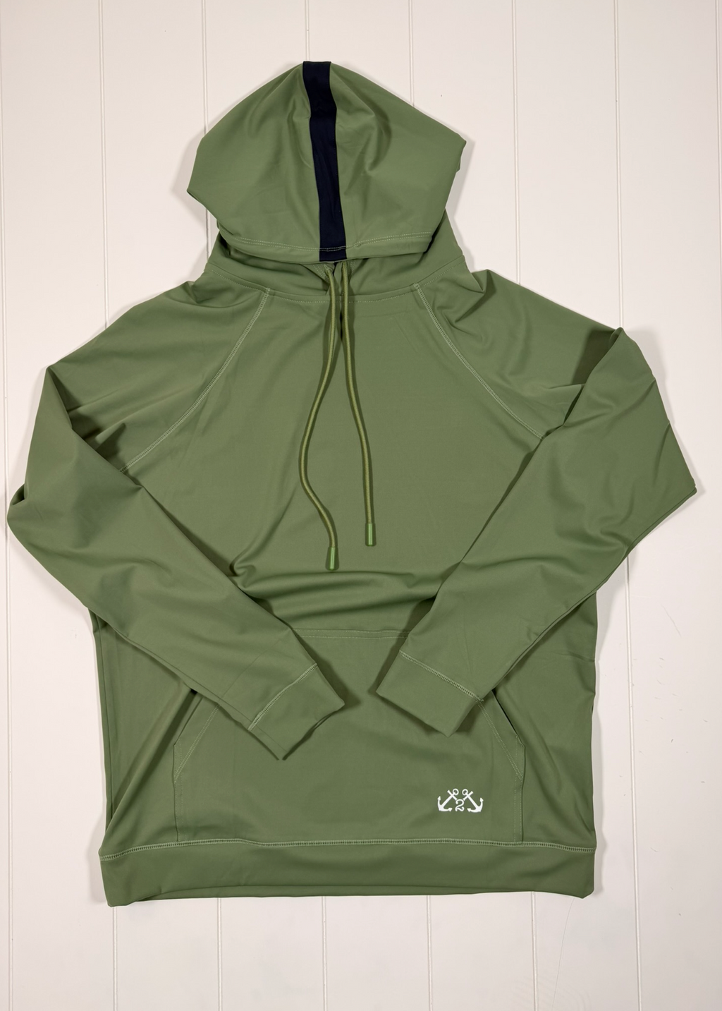 Green hoodie with a brand logo on a white wooden background