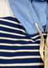 Close-up of a blue and white striped garment with a light blue hood.