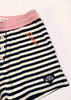 Close-up of striped shorts with a pink waistband, white buttons, orange script embroidery, and a small black heart patch on a white background.