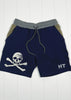 Navy shorts with skull and crossbones design and 'HT' branding on a white wooden background