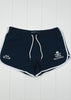 Navy blue shorts with white drawstring and branding on a white wooden background