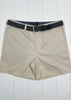 Beige shorts with a black belt on a white wooden background