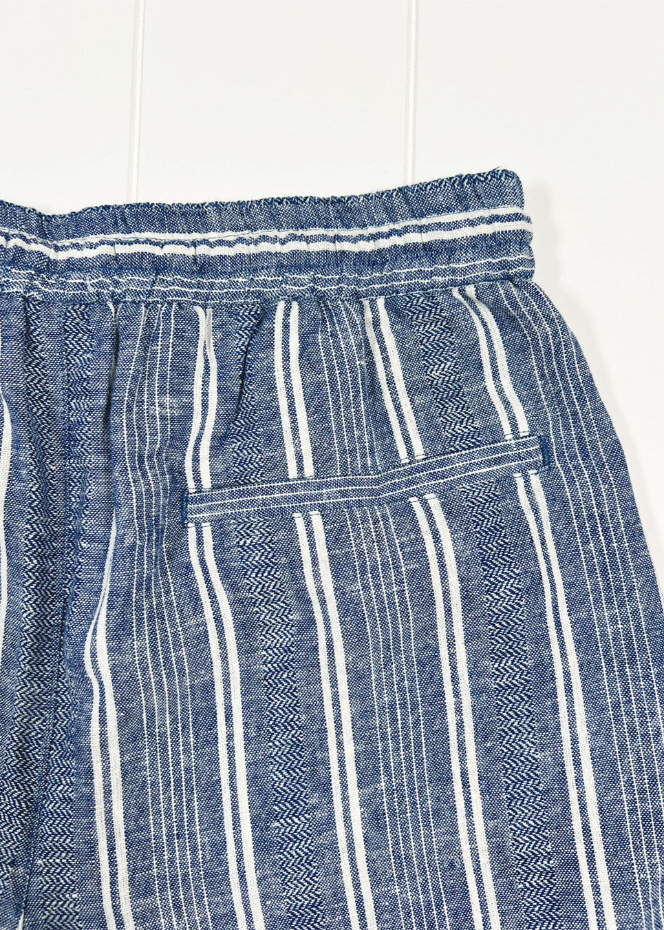 Blue and white striped pants on a white background