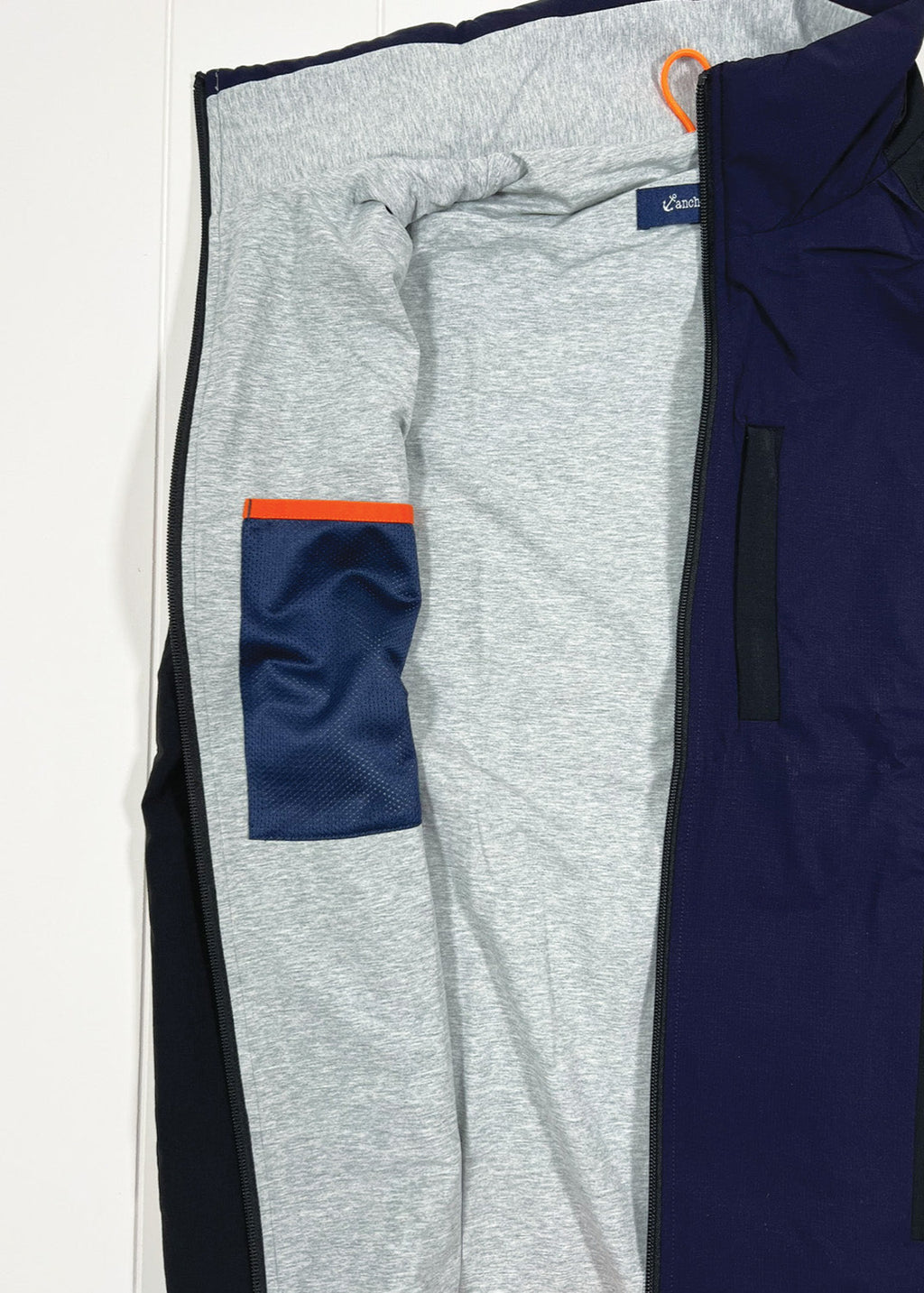 Gray and navy athletic pants with a pocket on a white background