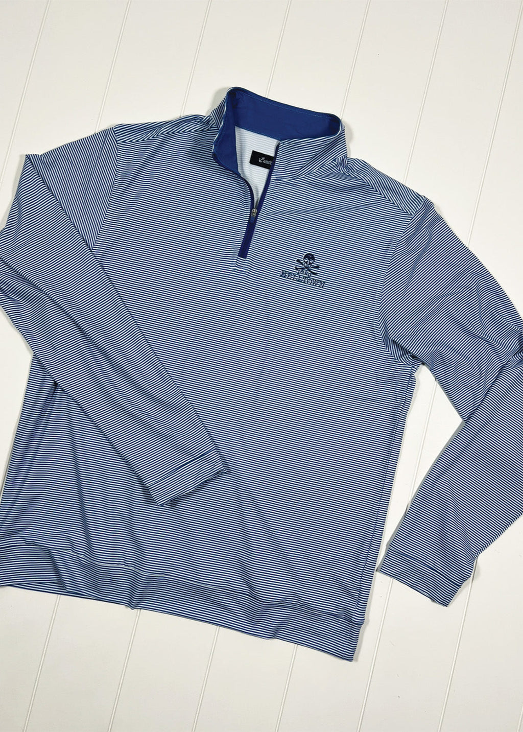 Blue striped long-sleeve shirt with a logo on a white background