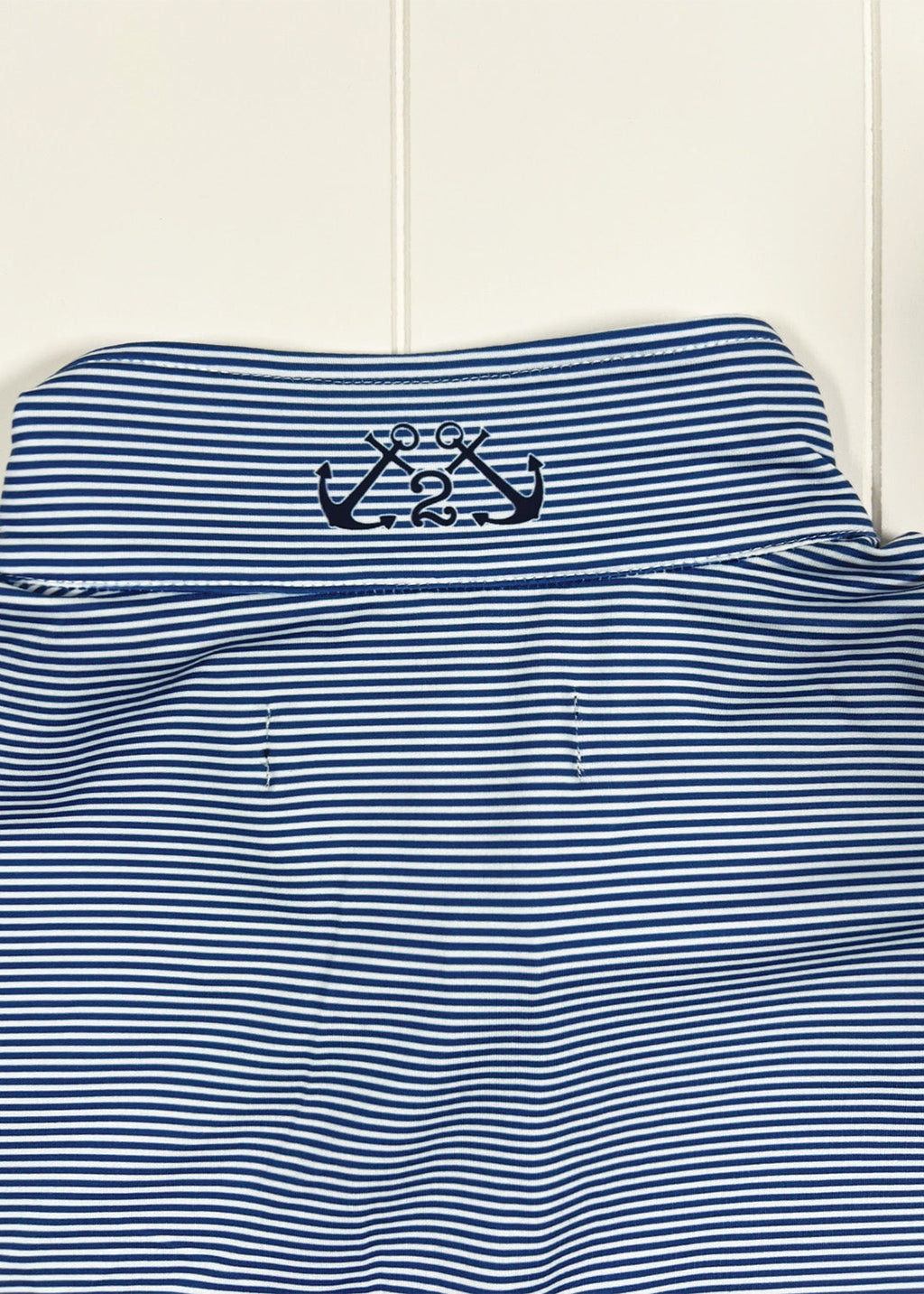 Blue and white striped shirt with a logo on a white background