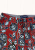 Red floral patterned fabric with a visible brand label on a white background