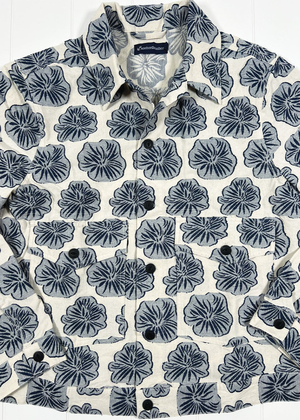 Floral patterned shirt with a brand label on a white background