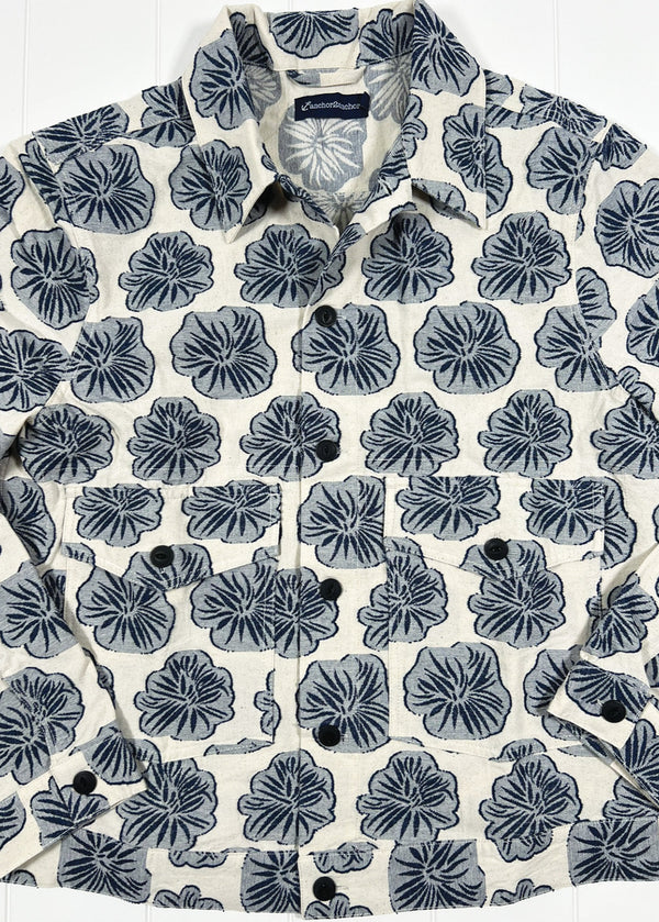 Floral patterned shirt with a brand label on a white background