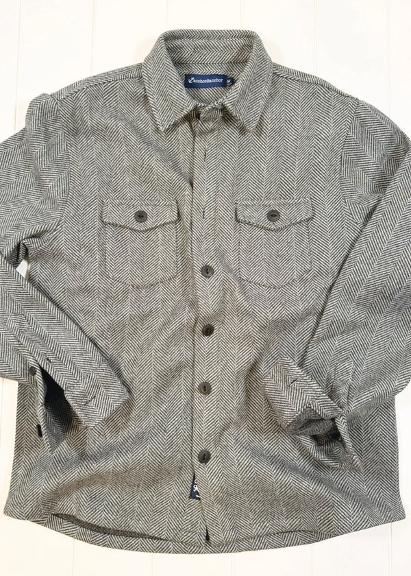 Green and gray checkered shirt with button details on a white background