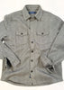 Green and gray checkered shirt with button details on a white background