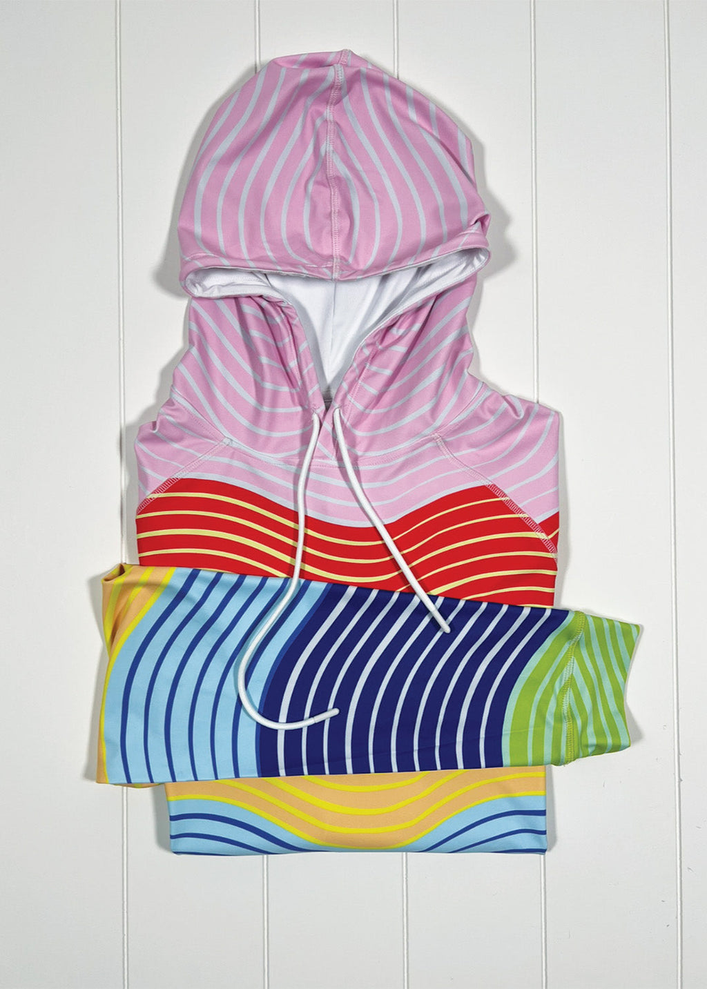 Colorful striped hoodie on a white wooden background