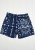 Blue shorts with white bandana pattern on a white background