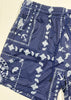 Blue shorts with white patterns on a plain background