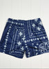 Navy blue shorts with white pattern on a white wooden background