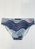 Navy and white striped swim bottom on a light wooden floor